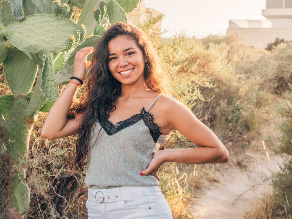 Playful trendy young woman in deserted countryside
