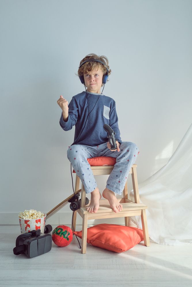 Upset boy in headphones playing video game