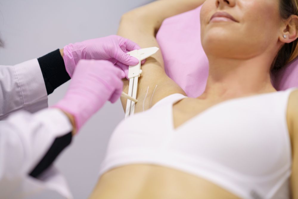 Woman with arm up in medical spa for treatment