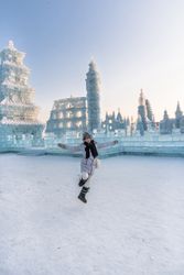 Cheerful female near ice oriental temple
