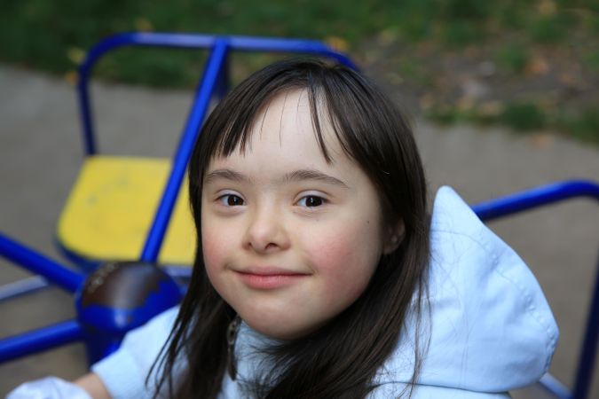 Close up portrait of young girl playing outdoors