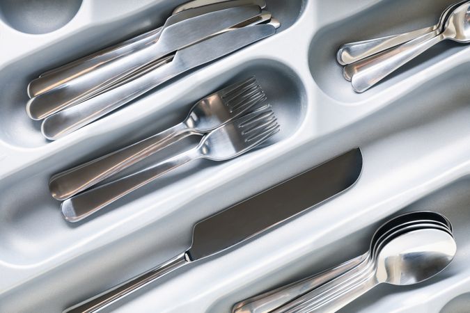 Set of different cutlery on whole background, close up