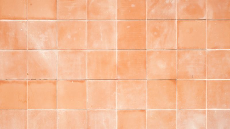 Orange porcelain tile wall with glossy surface and square pattern