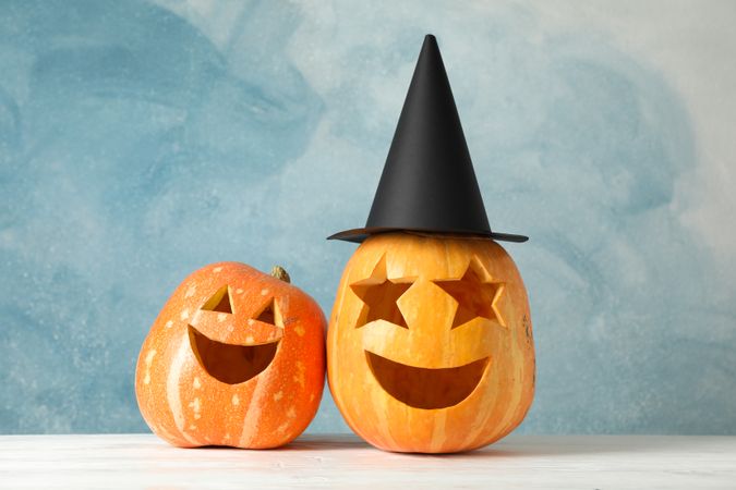 Funny pumpkins on wooden background, space for text