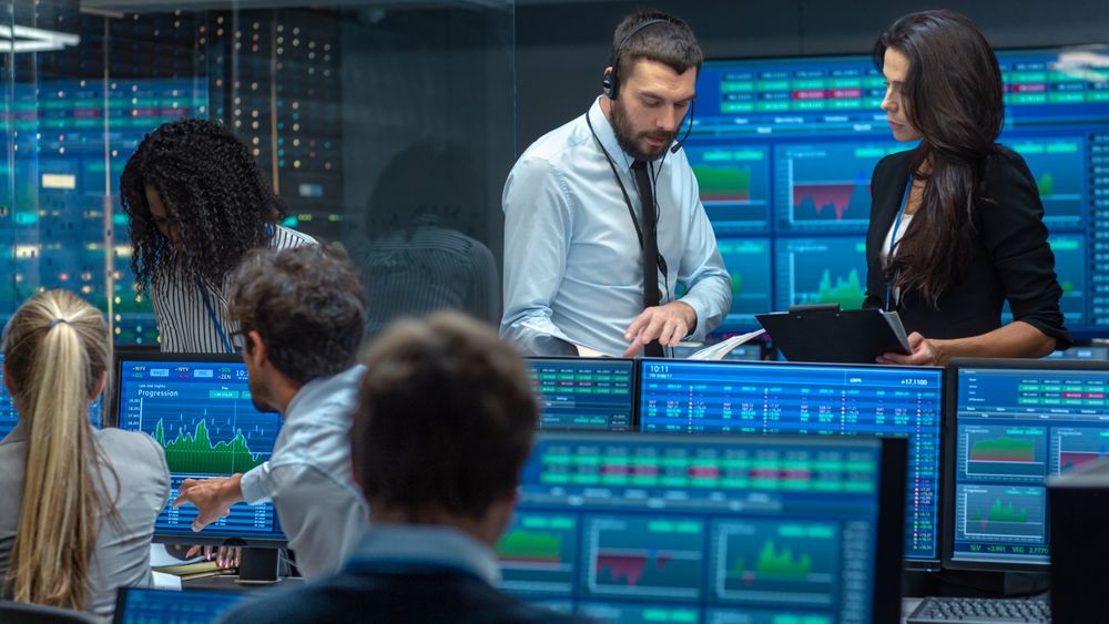 Multi-Ethnic Team of Traders is Busy Working at the Stock Exchange Office.