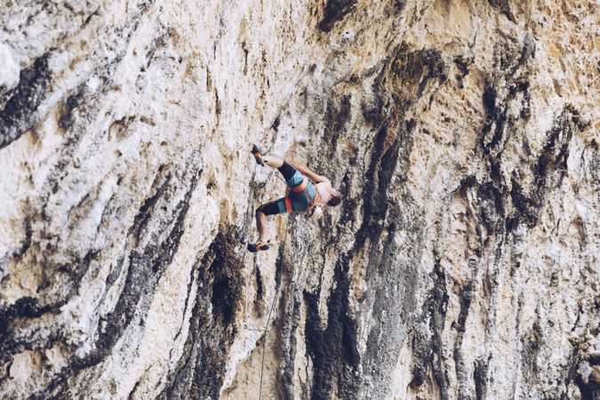 Anonymous man climbing rock