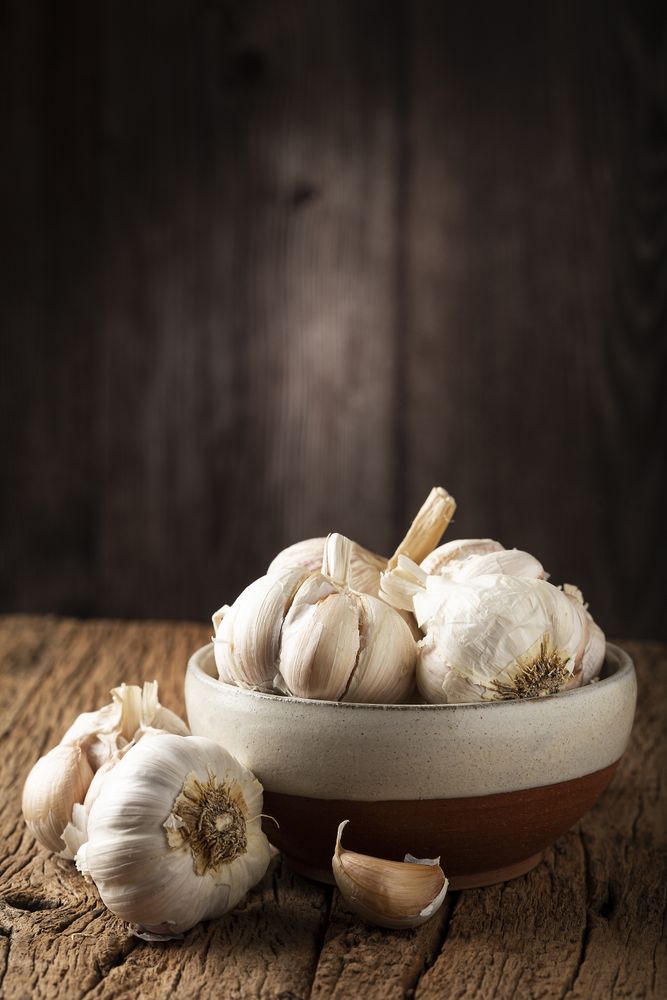 Garlic bulb and garlic cloves on the wooden table.