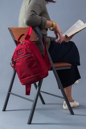 Back view of student sitting on chair holding a book