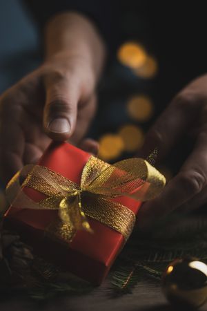 Man holding Christmas gift in hands