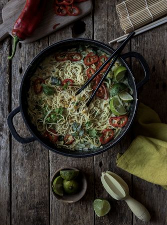 Green curry noodles in pot on table