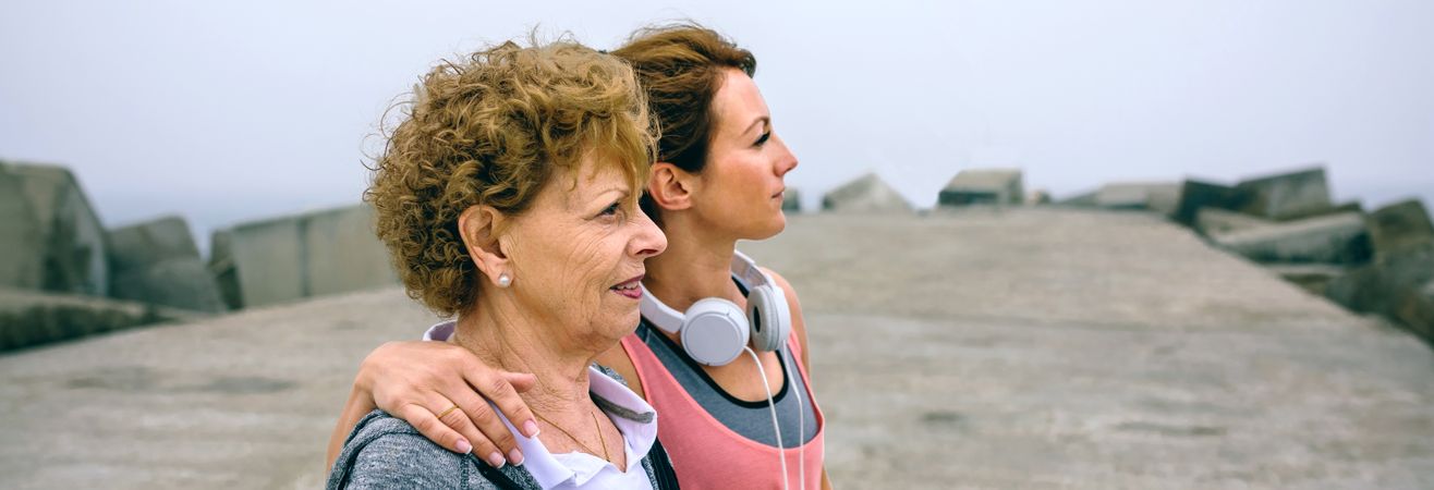 Mature and young sportswoman looking away