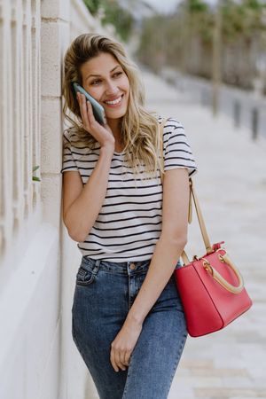 Woman using phone on city street