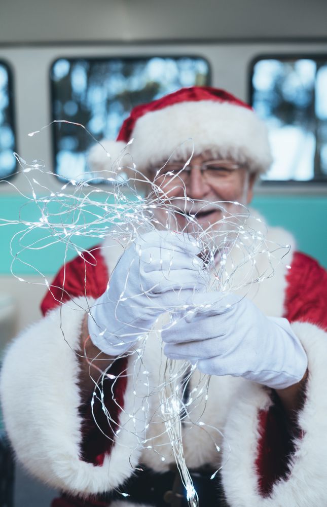 Santa Claus sitting with gifts and garland