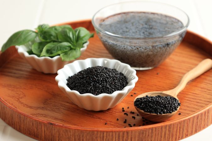 Close Up Organic Basil Seeds or Selasih on Wooden Tray. Superfood.