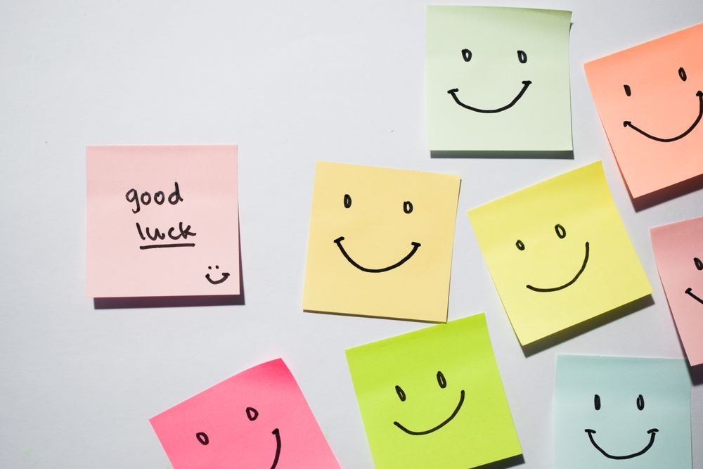 Good Luck and smile emoticon on sticky notes