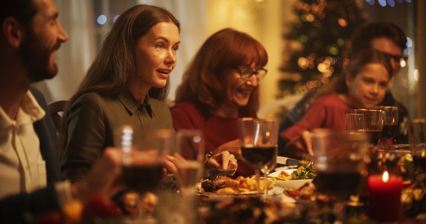 Portrait of a Female Enjoying a Delicious Turkey Dish and a Pleasant Conversation with Relatives.