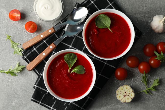 Tomato soup bowls on kitchen towel