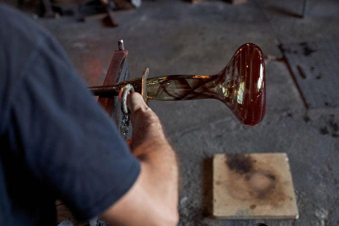 Crop craftsman making glass hookah base in workshop