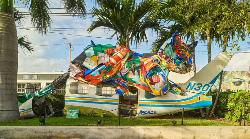 Colorful abstract sculpture of cat on airplane in Miami