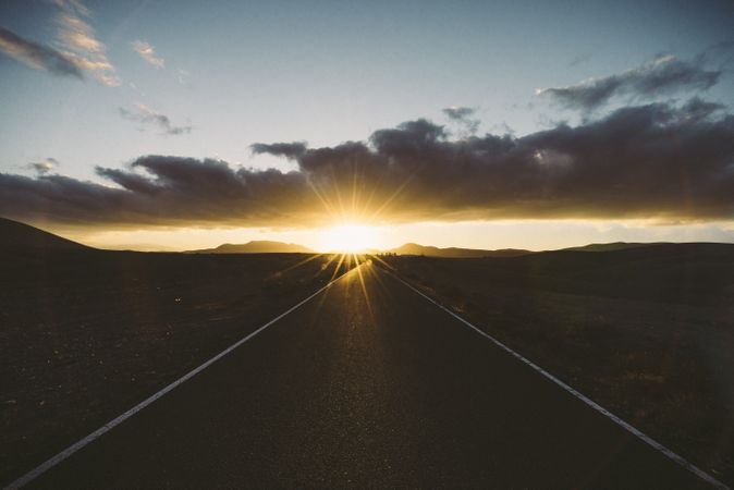Sunset with sunflare from an isolated road