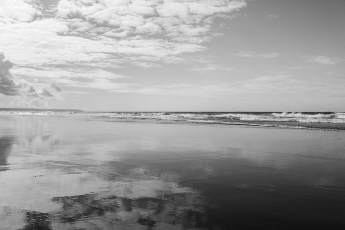 Cloudy day at the coast reflected in the ocean