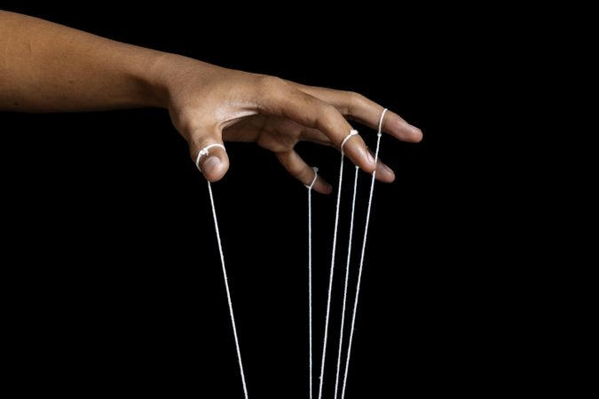male puppeteer hand with strings