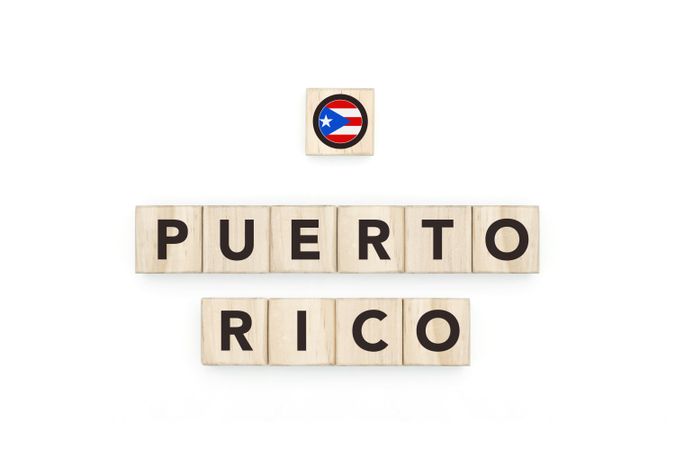 Wooden blocks bearing the name and flag of Puerto Rico. Puerto Rican and Caribbean Culture, national identity, travel, and geography in a copy space design.
