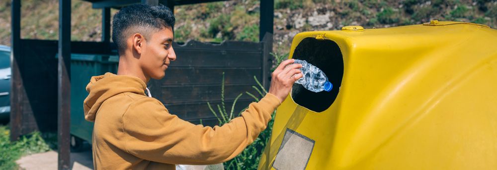 Man throwing garbage to container