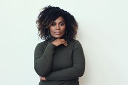 Black woman with her hand under her chin