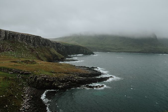 Misty rocky hills around coastline in Scotland