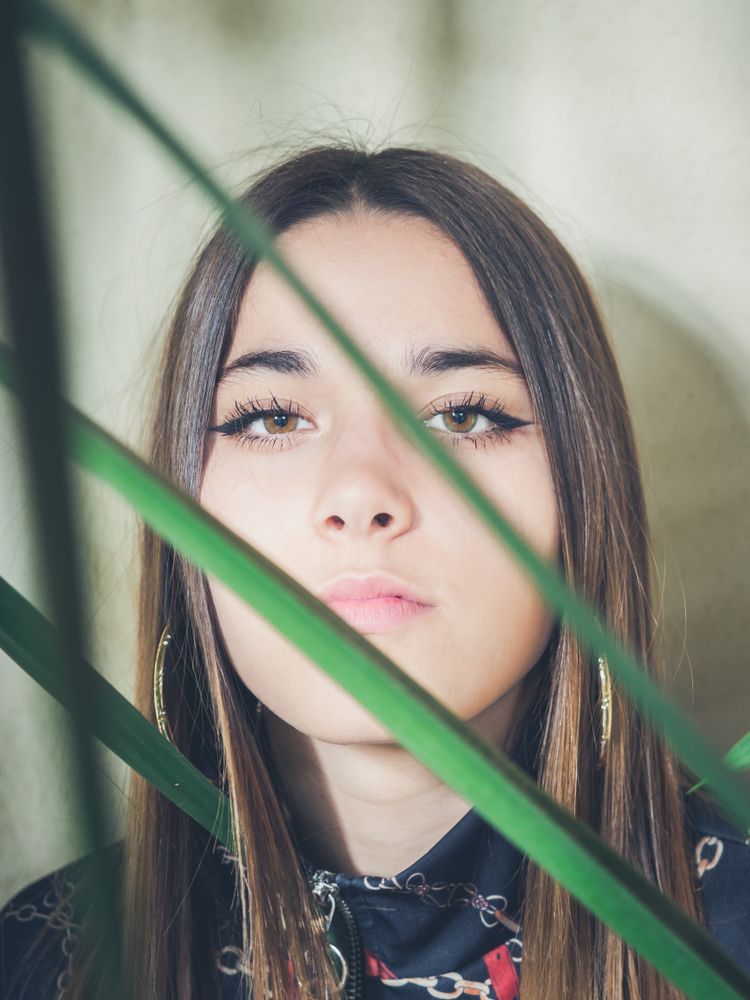 Woman between green leaves