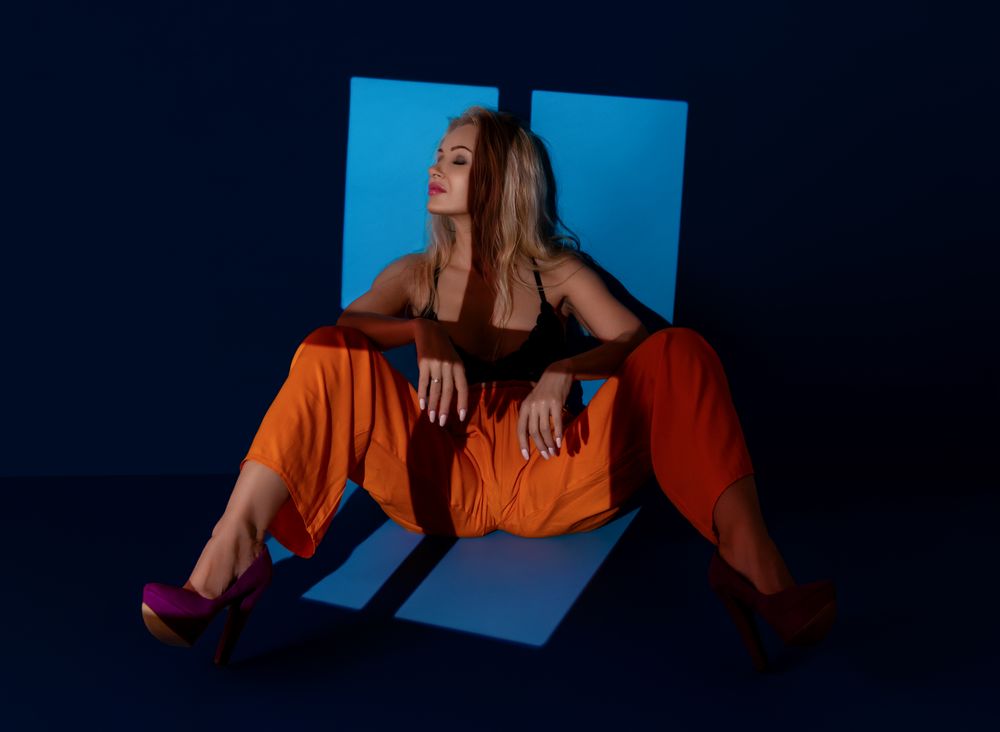 Woman leaning on a wall in a bright window light