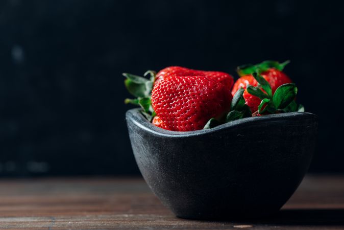 Fresh ripe strawberries in concrete bowl