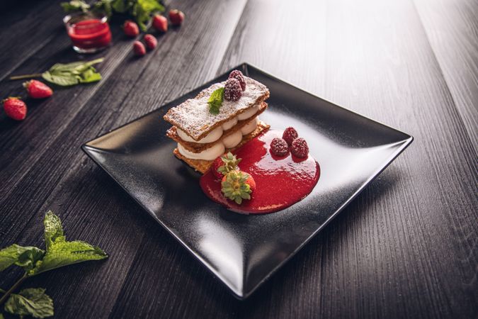 Diphlomate cream and red fruit strudel in elegant black plate