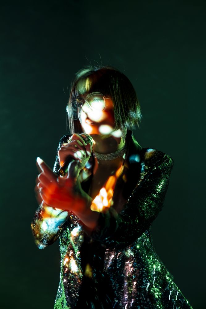 Stylish woman singing on stage