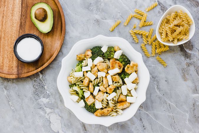 Bowl of cut chicken broccoli macaroni and cheese