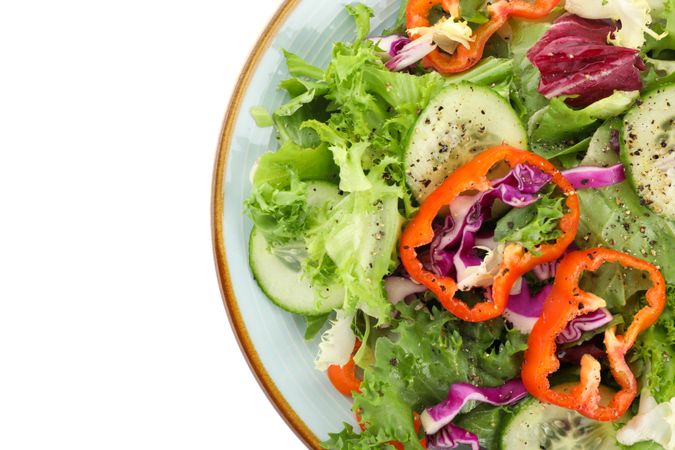 Plate with fresh salad isolated on plain background