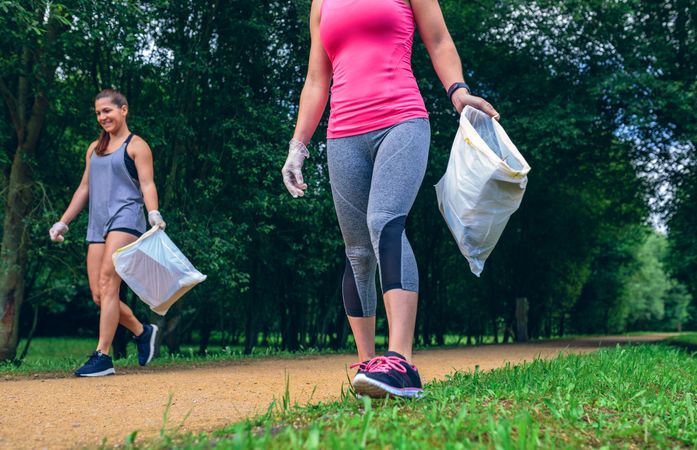 Woman with garbage bag doing plogging