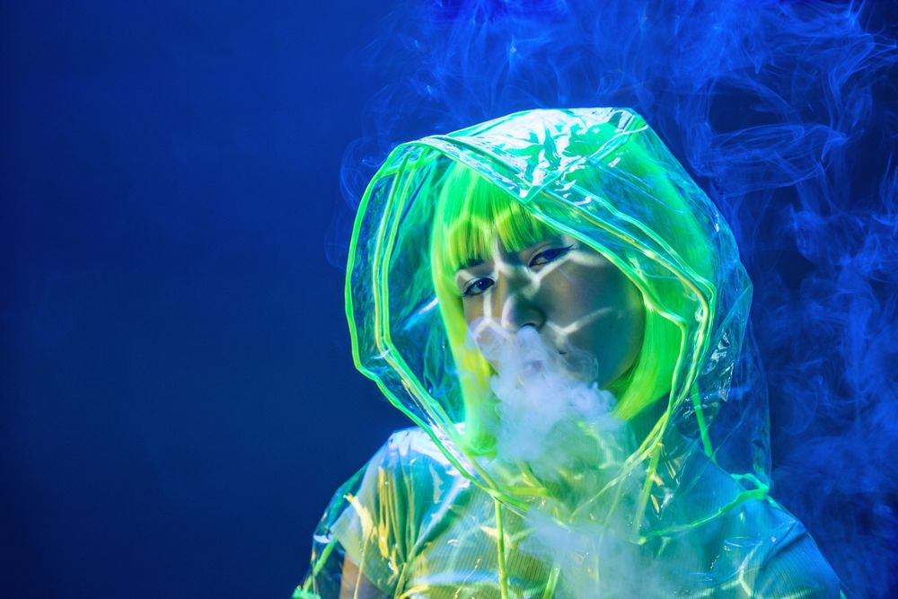 Asian woman smoking in fluorescent light