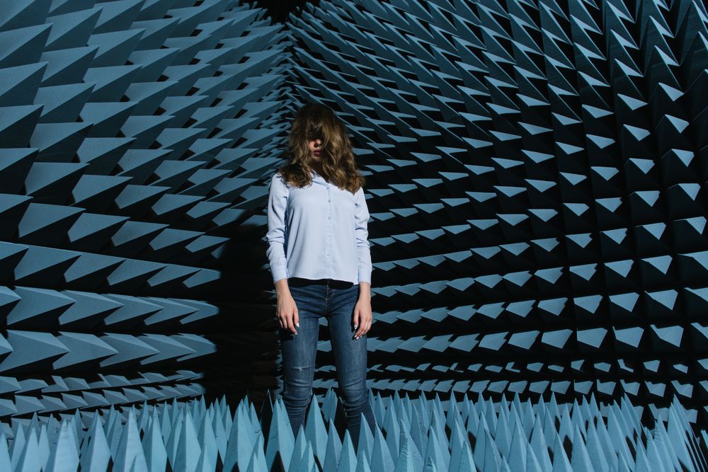 Woman in middle of sound room shaking head