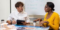 Two colleagues having meeting discussing project
