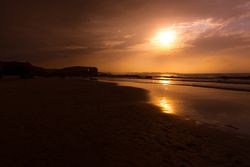 Beautiful evening sky over waving sea and shore