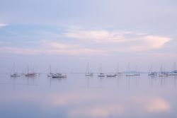 Boats on calm sea water in evening