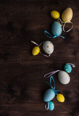 Top view of Easter card concept with colorful eggs scattered on table