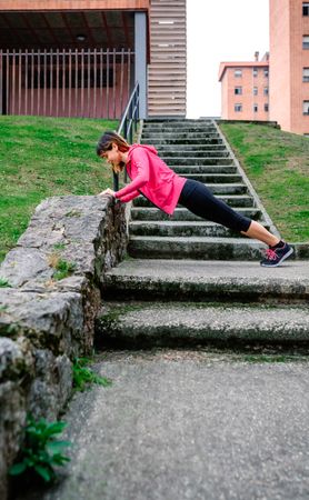 Female athlete doing push-ups outdoors