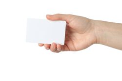 Female hand holding blank business card, isolated on plain background