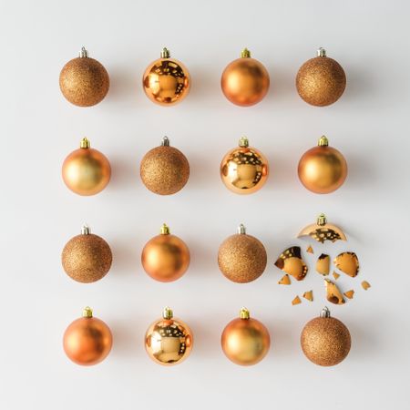 Golden Christmas baubles decoration on light background