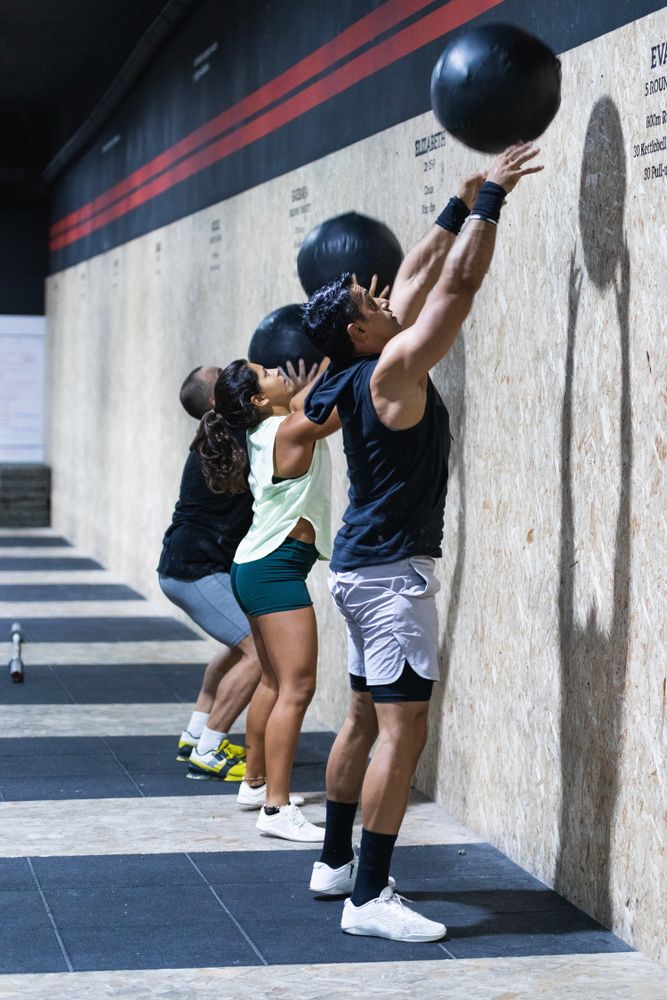 Hispanic sportspeople training with medical balls