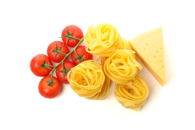 Tasty pasta and ingredients isolated on plain background