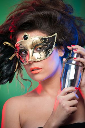 Woman in mask holding shaker